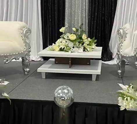 A table with flowers and two chairs on it