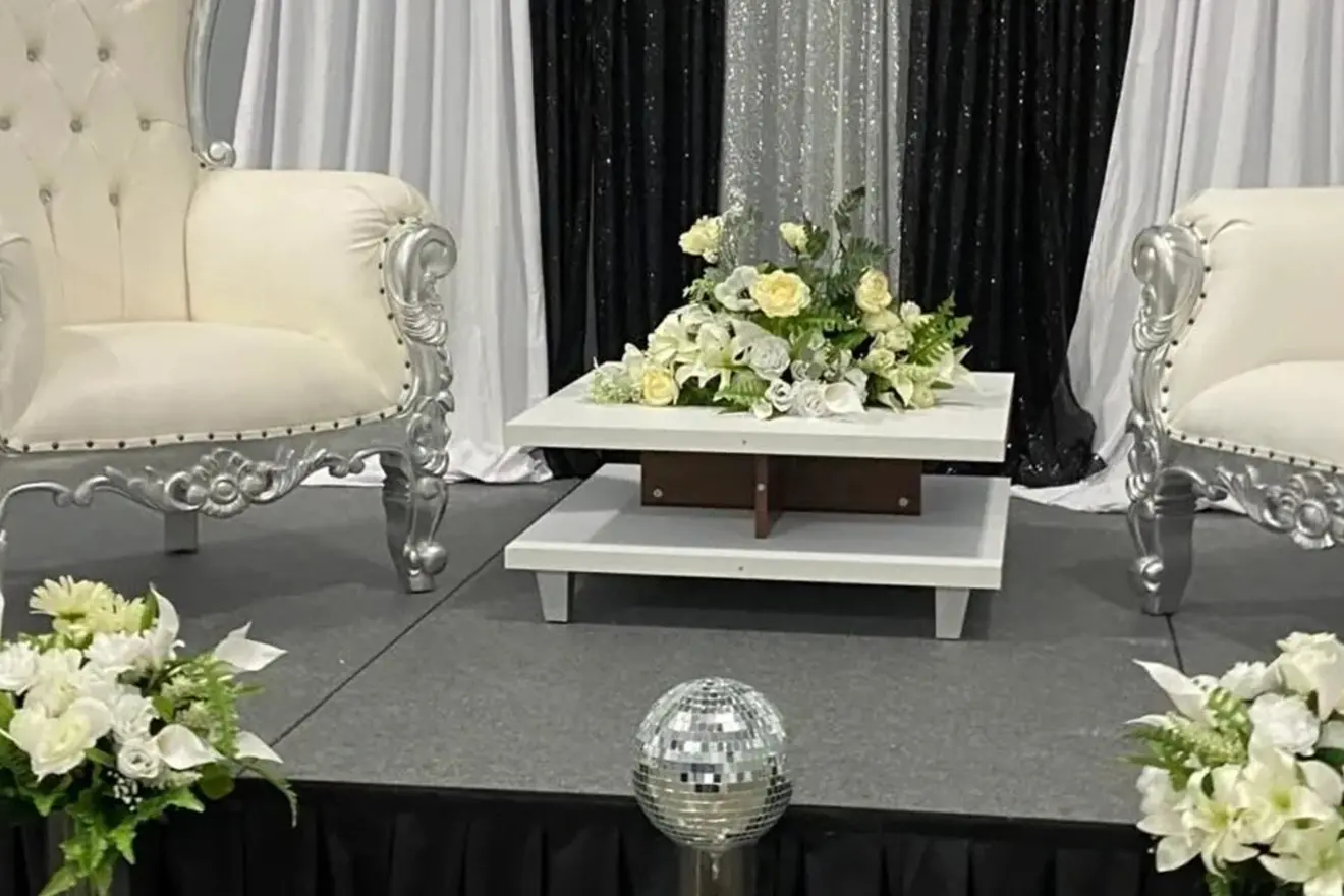 A white chair and table with flowers on it