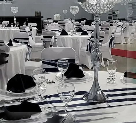 A table set for an event with black and white striped linens.